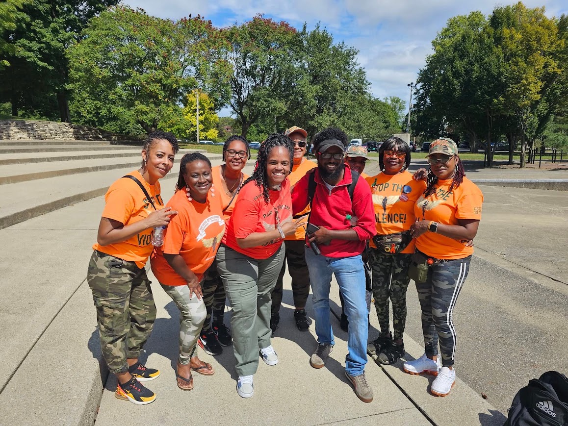 DaVante' Goins with organizers at an outdoor anti-violence community walk